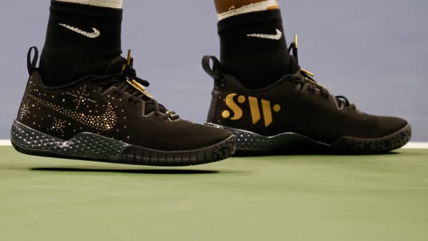 View of Serena Williams' black and gold Nike shoes.